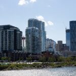 East Village condo towers and downtown skyline across the Bow River from the RiverWalk, Calgary