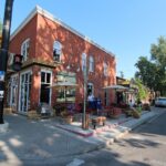 Brick corner cafe with patio on a summer day in Kensington, Calgary