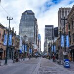 Historic sandstone buildings lining Stephen Avenue Walk with downtown towers, Calgary